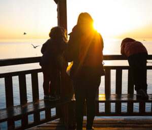 Mother with young Children with sunset in background