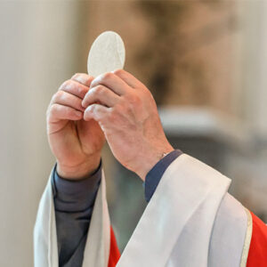 Priest holding the Consecrated Host during Catholic Mass